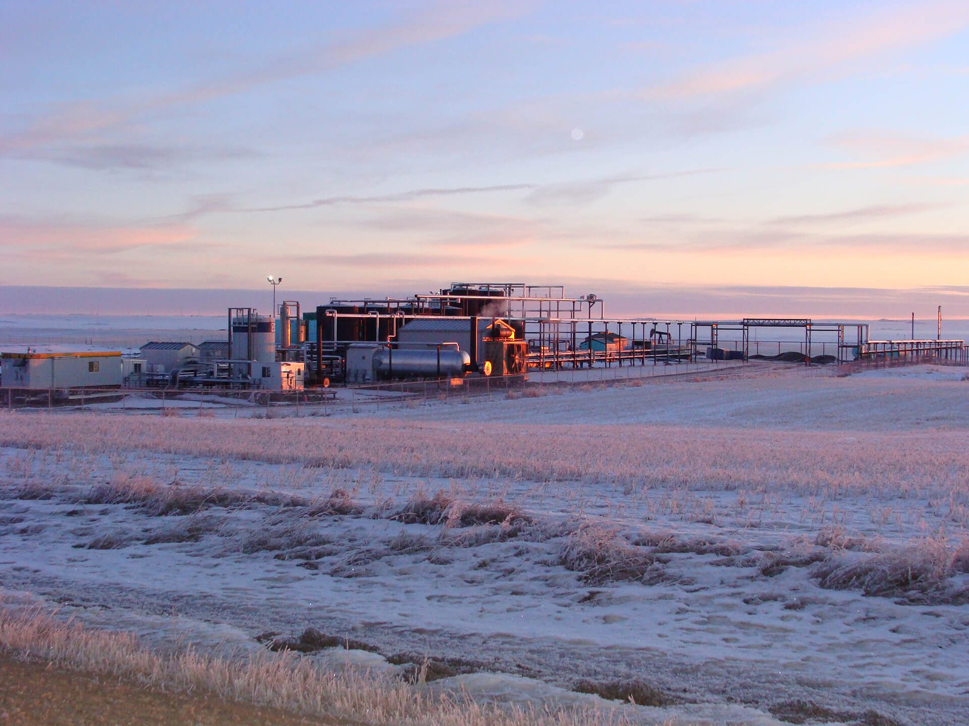 Oil battery in Alberta at sunrise
